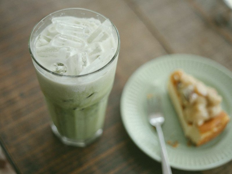 An iced matcha latte on a cafe table, before and after the matcha filter — matcha