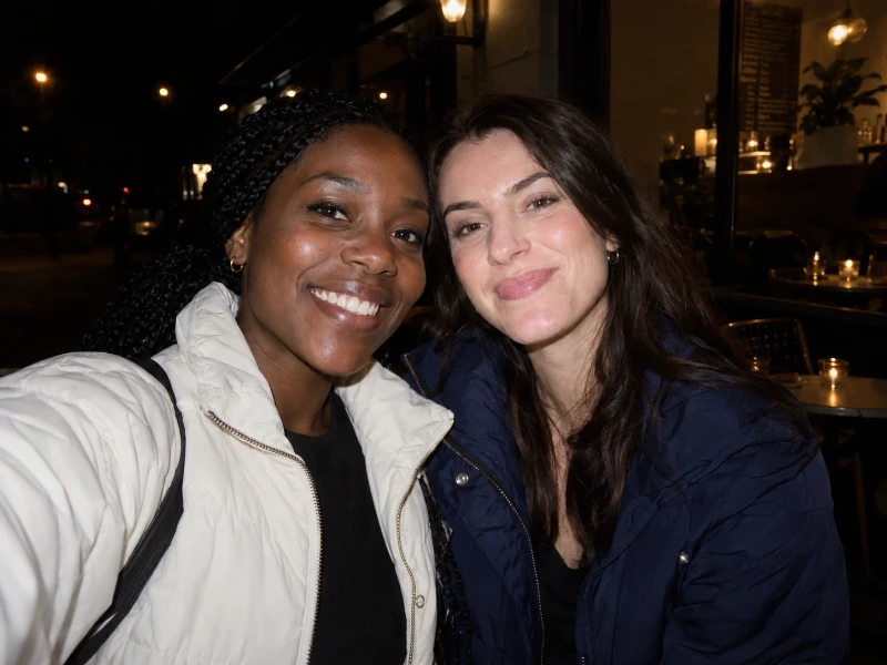 Generated direct-flash photograph of two friends outside a cafe at night — 45% strength